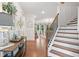 Bright foyer with wood floors, staircase, and decorative accents, creating an inviting entrance at 4120 Winterberry Rd, Cumming, GA 30040
