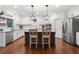 Bright kitchen features stainless steel appliances, white cabinets, and large island with seating at 4120 Winterberry Rd, Cumming, GA 30040