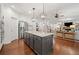 A great kitchen with island, granite countertops, stainless steel appliances, and opening to the living room at 4120 Winterberry Rd, Cumming, GA 30040