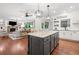 Open concept kitchen features granite countertops and island, and an adjoining living space at 4120 Winterberry Rd, Cumming, GA 30040
