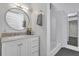 Modern bathroom featuring a marble vanity, round mirror, and a glass-enclosed shower with subway tile at 510 Edgewood Ne Ave # 6, Atlanta, GA 30312