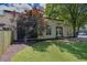 Exterior view featuring a well-kept lawn, a mature tree, and a beige building with dark-framed windows at 510 Edgewood Ne Ave # 6, Atlanta, GA 30312