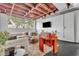Stylish living room showcasing a comfortable sofa, bold orange chair, large windows, and exposed ceiling beams at 510 Edgewood Ne Ave # 6, Atlanta, GA 30312