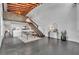 Open-concept living space featuring modern white kitchen, staircase, high ceilings, and industrial elements at 510 Edgewood Ne Ave # 6, Atlanta, GA 30312