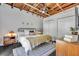 Cozy and bright main bedroom featuring neutral tones, modern furniture, and exposed beam ceiling at 510 Edgewood Ne Ave # 6, Atlanta, GA 30312