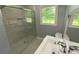 Bathroom featuring new shower with glass door, modern fixtures, and a window at 2251 S Hairston Rd, Decatur, GA 30035
