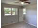 Bedroom with neutral carpet, ceiling fan, and two windows for natural light at 2251 S Hairston Rd, Decatur, GA 30035