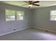 Bedroom with neutral carpet, ceiling fan, and two windows for natural light at 2251 S Hairston Rd, Decatur, GA 30035