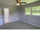 Bedroom with neutral carpet, ceiling fan, and two windows for natural light at 2251 S Hairston Rd, Decatur, GA 30035