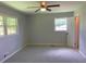 Bedroom with neutral carpet, ceiling fan, and two windows for natural light at 2251 S Hairston Rd, Decatur, GA 30035