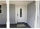 Covered entryway with columns, decorative glass door, and gray painted brick at 2251 S Hairston Rd, Decatur, GA 30035