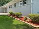 Charming exterior with light gray brick, flower beds, and manicured lawn at 2251 S Hairston Rd, Decatur, GA 30035