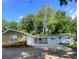 Charming single-story home featuring a stone facade, attached garage, and a spacious driveway at 2251 S Hairston Rd, Decatur, GA 30035