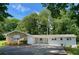 Charming stone and brick home with well-maintained landscaping and a lush green lawn at 2251 S Hairston Rd, Decatur, GA 30035