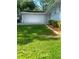 Exterior view of a two-car garage with manicured lawn and garden at 2251 S Hairston Rd, Decatur, GA 30035