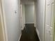Hallway with multiple doors and dark hardwood floors at 2251 S Hairston Rd, Decatur, GA 30035