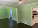 View of the living room with hardwood floors and openings to the kitchen and another room at 2251 S Hairston Rd, Decatur, GA 30035