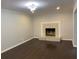 Open living room highlighting hardwood floors and a cozy fireplace at 2251 S Hairston Rd, Decatur, GA 30035