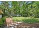 Spacious backyard featuring a lush lawn, stepping stones, and mature trees for added privacy at 3018 Monterey Dr, Decatur, GA 30032