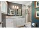 Modern bathroom featuring a glass-enclosed shower, double vanity with granite countertops, and contemporary fixtures at 3018 Monterey Dr, Decatur, GA 30032