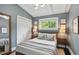 Bright bedroom with large windows, a double bed, hardwood floors, and a closet with sliding doors at 3018 Monterey Dr, Decatur, GA 30032