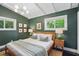 Cozy bedroom with dark green walls, recessed lighting, large windows, hardwood floors, and two end tables with lamps at 3018 Monterey Dr, Decatur, GA 30032