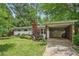 Inviting home exterior with a well-kept lawn, beautiful landscaping, and a convenient carport at 3018 Monterey Dr, Decatur, GA 30032