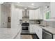 Well-equipped kitchen with stainless steel appliances, granite countertops, and white cabinetry at 3018 Monterey Dr, Decatur, GA 30032