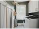 Laundry room featuring a washer, dryer, cabinets, and a window for natural light at 3018 Monterey Dr, Decatur, GA 30032