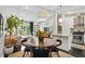 Open-concept living and dining area features modern decor, a large window, and a stylish kitchen with stainless steel appliances at 3018 Monterey Dr, Decatur, GA 30032
