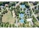 Aerial shot of tennis courts, a playground, and a community pool surrounded by trees and homes at 3642 River Club Dr, Cumming, GA 30041