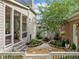Backyard courtyard offers an outdoor dining area on a stone patio, lush landscaping and private outdoor space at 3642 River Club Dr, Cumming, GA 30041