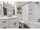 Bathroom featuring a quartz vanity, shelving, and a shower with white subway tile at 3642 River Club Dr, Cumming, GA 30041