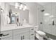 Bathroom featuring a double sink vanity, a glass-enclosed shower, and updated fixtures and finishes at 3642 River Club Dr, Cumming, GA 30041