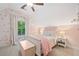 Cozy bedroom featuring soft pink hues, floral wallpaper, and natural light at 3642 River Club Dr, Cumming, GA 30041