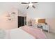 A charming bedroom with pink walls, a cozy work area, and black double doors at 3642 River Club Dr, Cumming, GA 30041