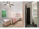 Charming bedroom featuring soft pink hues, floral wallpaper, and an attached bathroom at 3642 River Club Dr, Cumming, GA 30041