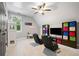 Bedroom area with game chairs, ceiling fan, natural light, and storage and display shelving at 3642 River Club Dr, Cumming, GA 30041