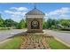 Entrance to the Chattahoochee River Club featuring a stone sign and manicured landscaping at 3642 River Club Dr, Cumming, GA 30041