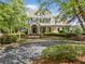 Traditional-style home with a stately front elevation, featuring a curved driveway and professional landscaping at 3642 River Club Dr, Cumming, GA 30041