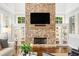 Living room with a floor-to-ceiling stone fireplace and built-in shelving at 3642 River Club Dr, Cumming, GA 30041