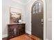Inviting foyer features dark wood floors, arched door, and furniture at 3642 River Club Dr, Cumming, GA 30041