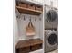 Functional laundry room with stacked washer and dryer and custom storage shelves at 3642 River Club Dr, Cumming, GA 30041