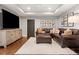 Cozy living room with a large sectional, television, decor, and a tray ceiling at 3642 River Club Dr, Cumming, GA 30041