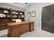 Home office with built-in shelving, a large desk, and carpeting at 3642 River Club Dr, Cumming, GA 30041