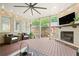 Covered patio with a stone fireplace and tv, offers relaxing seating for a backyard retreat at 3642 River Club Dr, Cumming, GA 30041