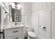 Stylish powder room featuring a modern vanity, white walls and wallpaper accent at 3642 River Club Dr, Cumming, GA 30041