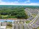 An aerial view of a community with wooded areas and a model home inset at 207 Hickory Bluffs Pkwy, Canton, GA 30114