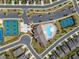 Aerial view of the community amenities with tennis courts, pool and clubhouse and ample parking spaces at 207 Hickory Bluffs Pkwy, Canton, GA 30114