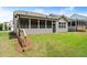 Beautiful backyard featuring a screened-in porch and freshly landscaped yard with green grass at 207 Hickory Bluffs Pkwy, Canton, GA 30114